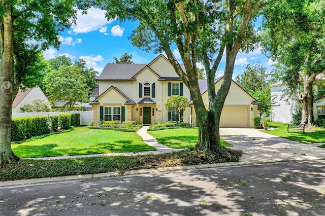 991 Hawthorne Cove Ct, Ocoee, FL 34761 - traditional-style home with stucco siding, driveway, and a garage