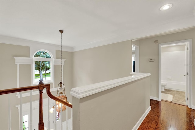 991 Hawthorne Cove Ct, Ocoee, FL 34761 - hall featuring an upstairs landing, dark wood finished floors, crown molding, and recessed lighting
