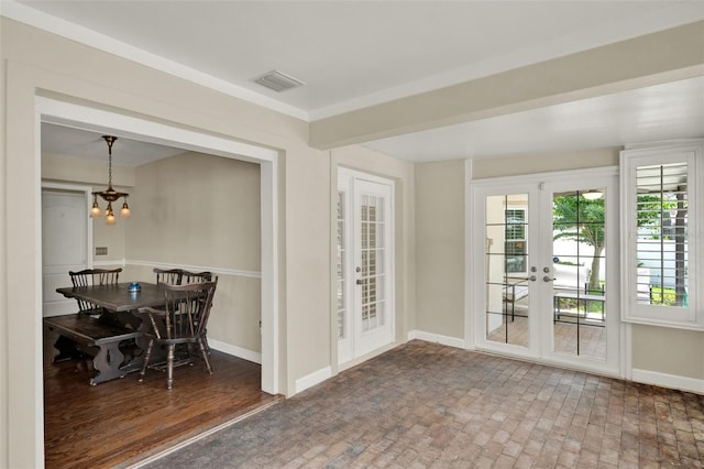 991 Hawthorne Cove Ct, Ocoee, FL 34761 - dining area featuring french doors, a chandelier, and brick patterned floors