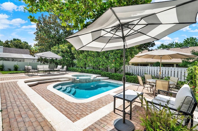991 Hawthorne Cove Ct, Ocoee, FL 34761 - view of swimming pool with a patio, a fenced backyard, a pool with connected hot tub, and outdoor dining space