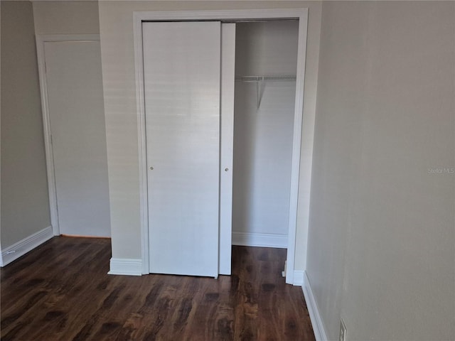 13546 Summerton Dr, Orlando, FL 32824 - unfurnished bedroom with dark wood finished floors and a closet