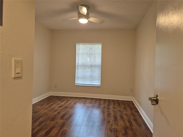 13546 Summerton Dr, Orlando, FL 32824 - spare room featuring dark wood-style floors, ceiling fan, a textured ceiling, and a textured wall