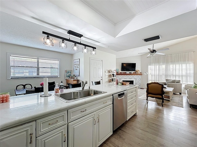 260 Killarney Bay Ct Unit 6-6, Winter Park, FL 32789 - kitchen featuring stainless steel dishwasher, open floor plan, a fireplace, and light countertops