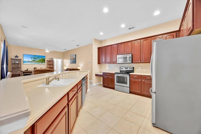 3954 Old Dunn Rd, Apopka, FL 32712 - kitchen with stainless steel appliances, a sink, backsplash, open floor plan, and light countertops
