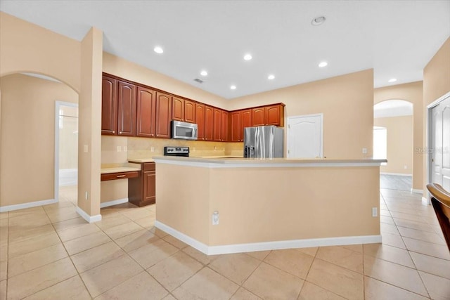 3954 Old Dunn Rd, Apopka, FL 32712 - kitchen featuring stainless steel appliances, arched walkways, light tile patterned flooring, light countertops, and decorative backsplash