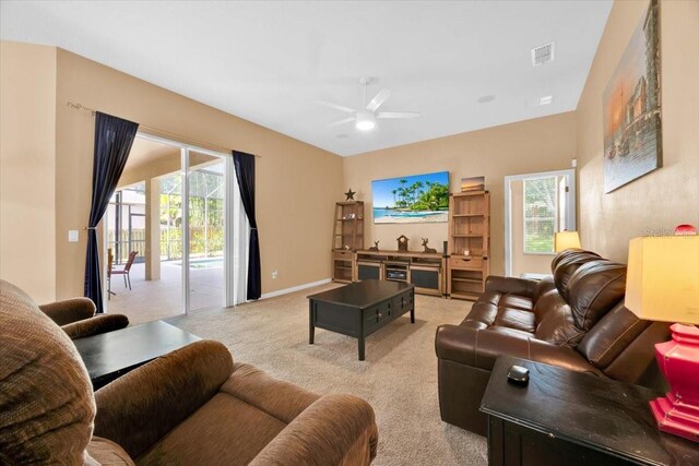 3954 Old Dunn Rd, Apopka, FL 32712 - living area featuring carpet flooring, ceiling fan, healthy amount of natural light, and baseboards