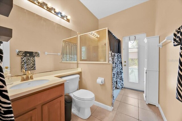 3954 Old Dunn Rd, Apopka, FL 32712 - bathroom featuring tile patterned floors, vanity, toilet, tiled shower, and baseboards