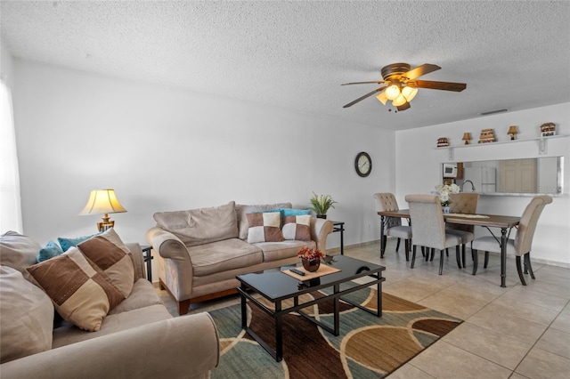 8116 Parrot Dr, Orlando, FL 32825 - living area featuring ceiling fan, a textured ceiling, and light tile patterned flooring