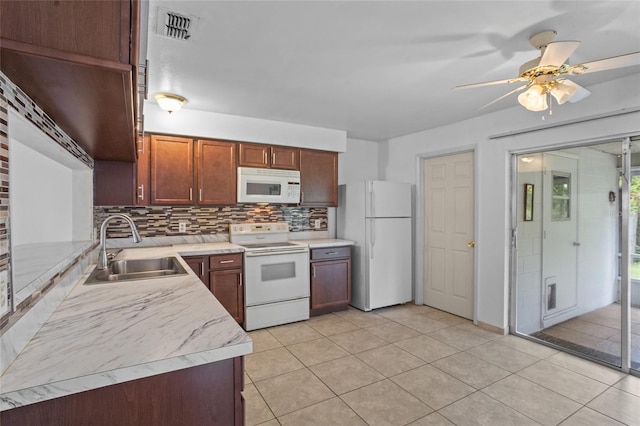 8116 Parrot Dr, Orlando, FL 32825 - kitchen with white appliances, decorative backsplash, light countertops, a ceiling fan, and light tile patterned floors