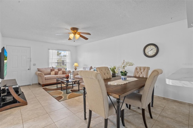 8116 Parrot Dr, Orlando, FL 32825 - dining area featuring ceiling fan, light tile patterned floors, and a textured ceiling