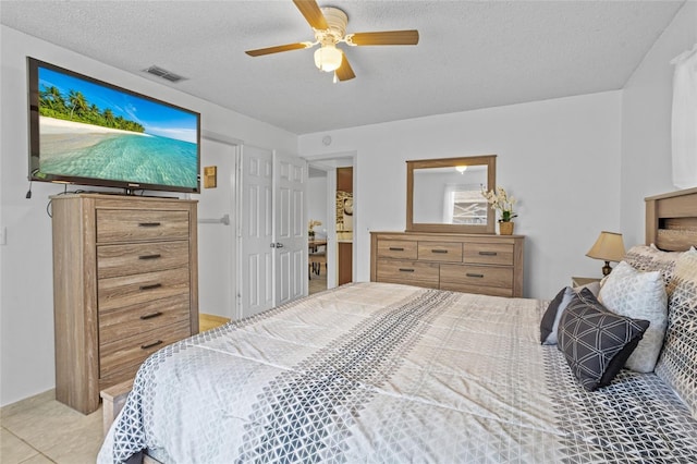 8116 Parrot Dr, Orlando, FL 32825 - bedroom with a textured ceiling, ceiling fan, and light tile patterned floors