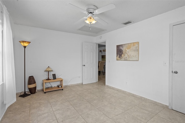 8116 Parrot Dr, Orlando, FL 32825 - spare room featuring light tile patterned flooring, a ceiling fan, and attic access
