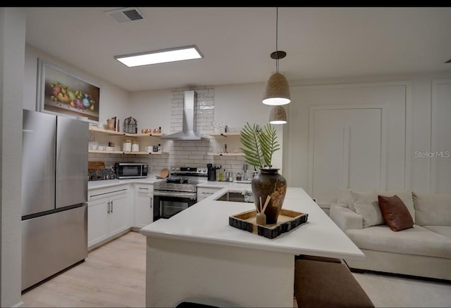 3176 Feltrim Pl Unit 302, Kissimmee, FL 34747 - kitchen with appliances with stainless steel finishes, wall chimney exhaust hood, open shelves, backsplash, and light countertops