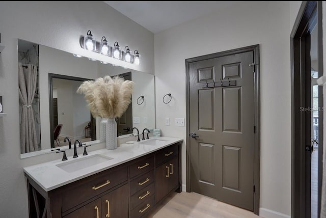3176 Feltrim Pl Unit 302, Kissimmee, FL 34747 - bathroom featuring double vanity and wood finished floors