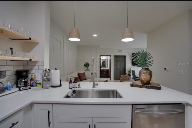 3176 Feltrim Pl Unit 302, Kissimmee, FL 34747 - kitchen featuring dishwasher, open shelves, white cabinetry, light countertops, and decorative backsplash