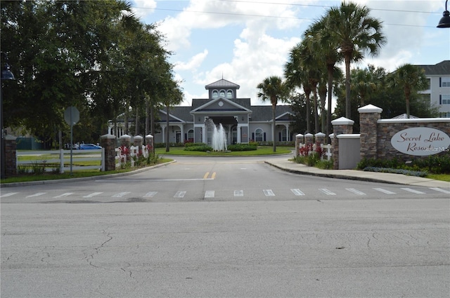 3176 Feltrim Pl Unit 302, Kissimmee, FL 34747 - view of asphalt street featuring curbs, traffic signs, street lights, and sidewalks