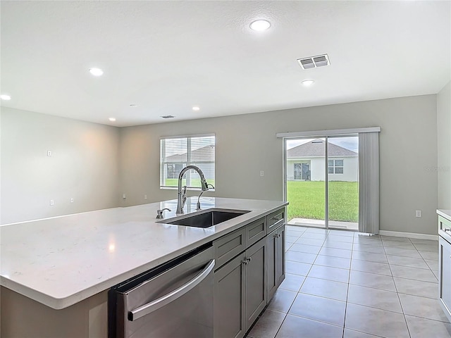 3975 Silverstream Ter, Sanford, FL 32771 - kitchen featuring dishwasher, recessed lighting, light tile patterned floors, a center island with sink, and light stone counters