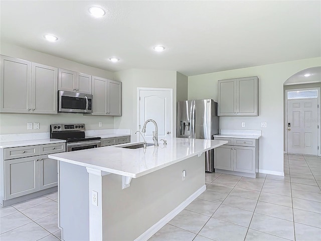 3975 Silverstream Ter, Sanford, FL 32771 - kitchen with stainless steel appliances, gray cabinets, light tile patterned floors, and recessed lighting