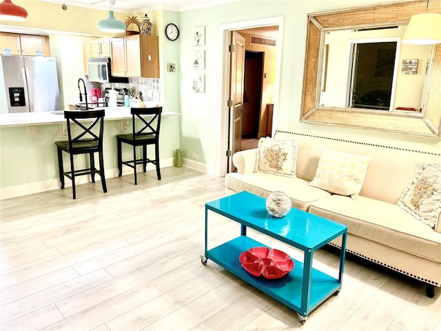 151 E Washington St Unit 508, Orlando, FL 32801 - living area featuring ornamental molding and light wood finished floors