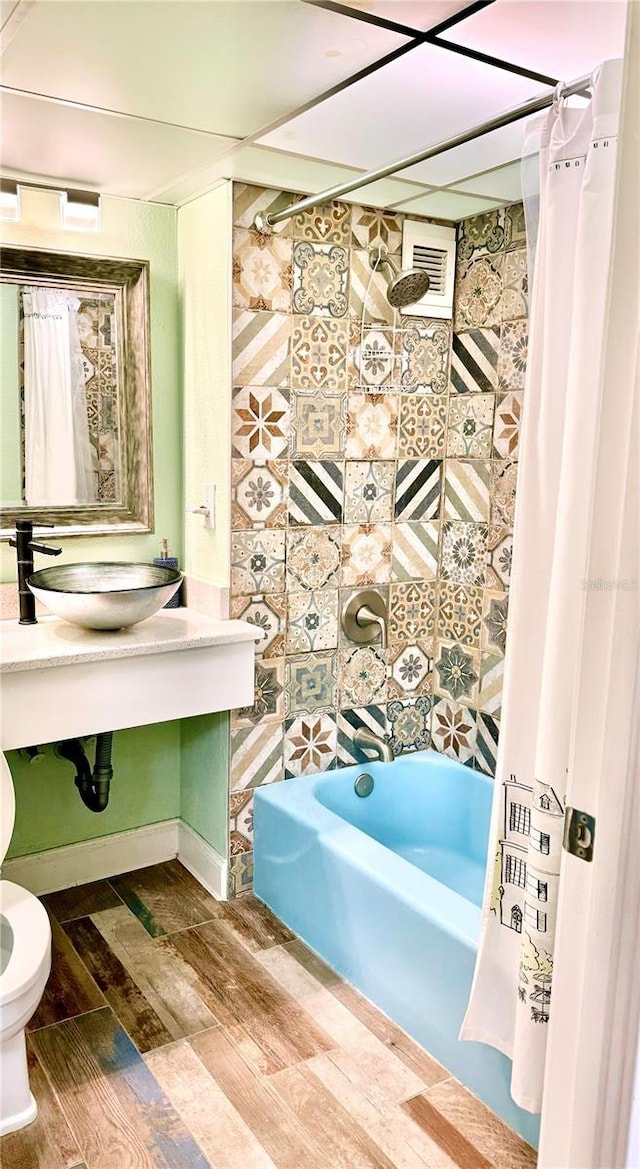 151 E Washington St Unit 508, Orlando, FL 32801 - full bathroom featuring wood finished floors and shower / tub combo