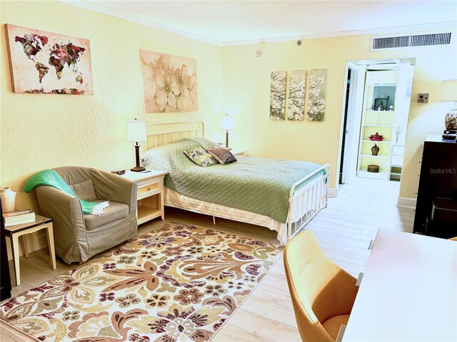 151 E Washington St Unit 508, Orlando, FL 32801 - bedroom with crown molding, wood finished floors, and a textured wall