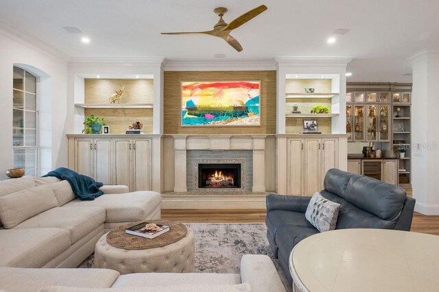 6047 Blakeford Dr, Windermere, FL 34786 - living room with wood finished floors, a ceiling fan, ornamental molding, a large fireplace, and recessed lighting