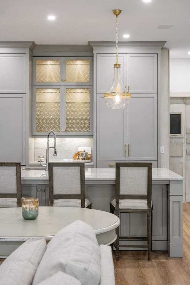 6047 Blakeford Dr, Windermere, FL 34786 - kitchen with gray cabinetry, pendant lighting, wood finished floors, and recessed lighting