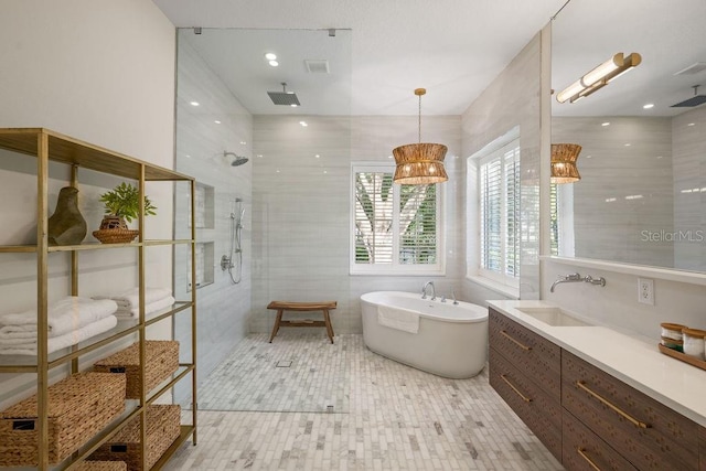 6047 Blakeford Dr, Windermere, FL 34786 - bathroom with walk in shower, a soaking tub, tile walls, and vanity