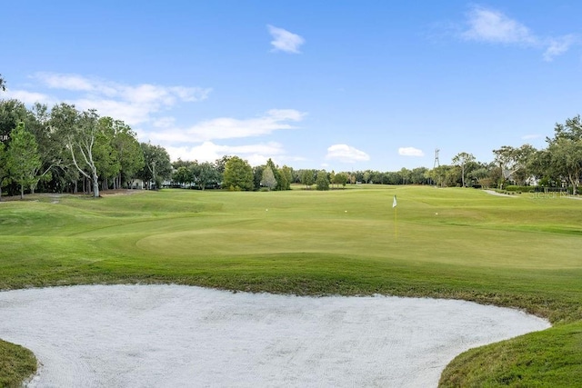 6047 Blakeford Dr, Windermere, FL 34786 - view of home's community with view of golf course, a lawn, and view of wooded area