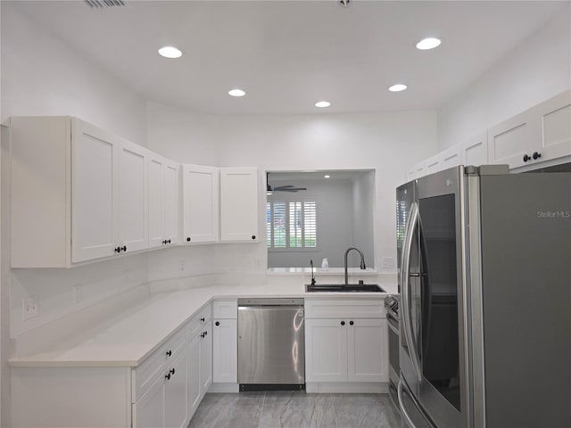 3030 Clubview Dr Unit Ge, Orlando, FL 32822 - kitchen featuring appliances with stainless steel finishes, light countertops, white cabinets, recessed lighting, and a ceiling fan