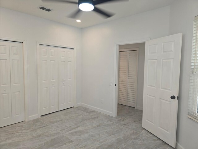 3030 Clubview Dr Unit Ge, Orlando, FL 32822 - unfurnished bedroom featuring two closets, light marble finish flooring, a ceiling fan, and recessed lighting