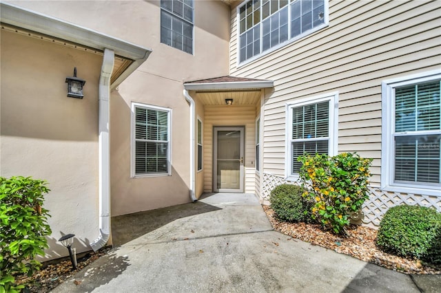 3030 Clubview Dr Unit Ge, Orlando, FL 32822 - view of exterior entry with stucco siding and a patio area