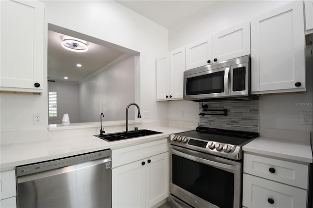 3030 Clubview Dr Unit Ge, Orlando, FL 32822 - kitchen featuring appliances with stainless steel finishes, ornamental molding, white cabinetry, and light countertops
