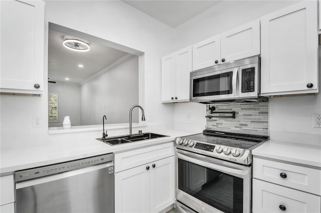 3030 Clubview Dr Unit Ge, Orlando, FL 32822 - kitchen with stainless steel appliances, light countertops, white cabinets, crown molding, and decorative backsplash