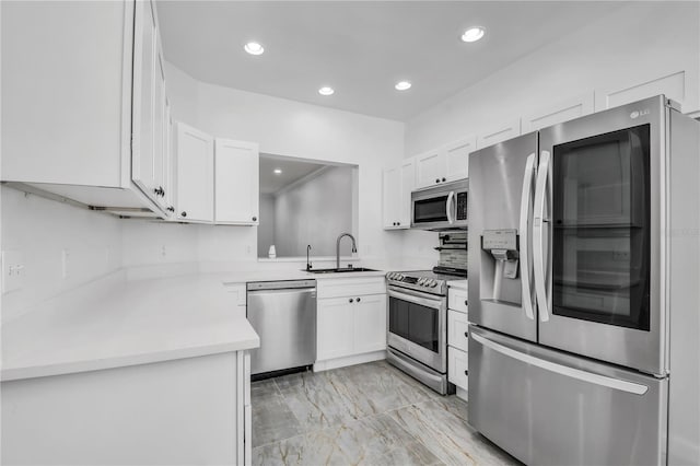 3030 Clubview Dr Unit Ge, Orlando, FL 32822 - kitchen with stainless steel appliances, light marble finish flooring, white cabinets, recessed lighting, and light countertops