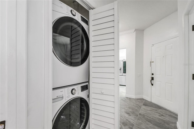 3030 Clubview Dr Unit Ge, Orlando, FL 32822 - washroom featuring stacked washing machine and dryer and marble look tile flooring