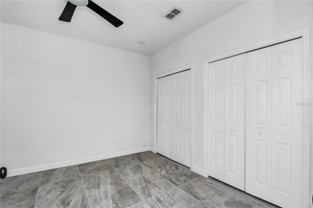 3030 Clubview Dr Unit Ge, Orlando, FL 32822 - unfurnished bedroom featuring two closets, ceiling fan, and marble finish flooring