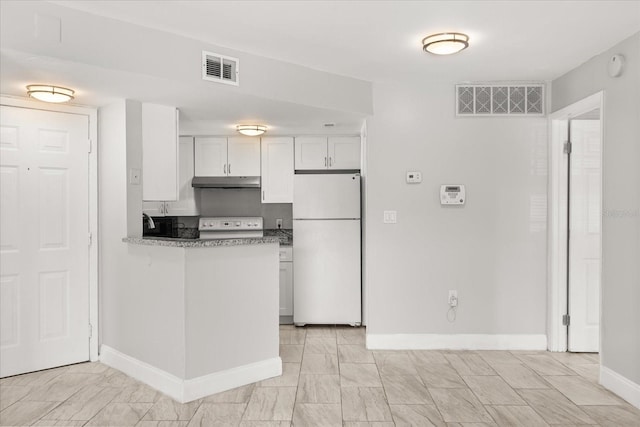 1924 Lake Atriums Cir Unit 52, Orlando, FL 32839 - kitchen with freestanding refrigerator, under cabinet range hood, range, white cabinets, and a peninsula
