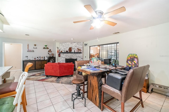 236 Longhorn Dr, Apopka, FL 32712 - dining space with light tile patterned floors, ceiling fan, and a brick fireplace