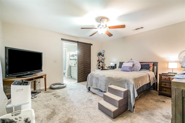 236 Longhorn Dr, Apopka, FL 32712 - carpeted bedroom featuring a barn door, ensuite bathroom, and a ceiling fan