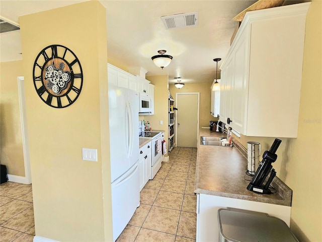 5037 S Obispo Cir, Labelle, FL 33935 - kitchen with white appliances, light tile patterned floors, and white cabinets