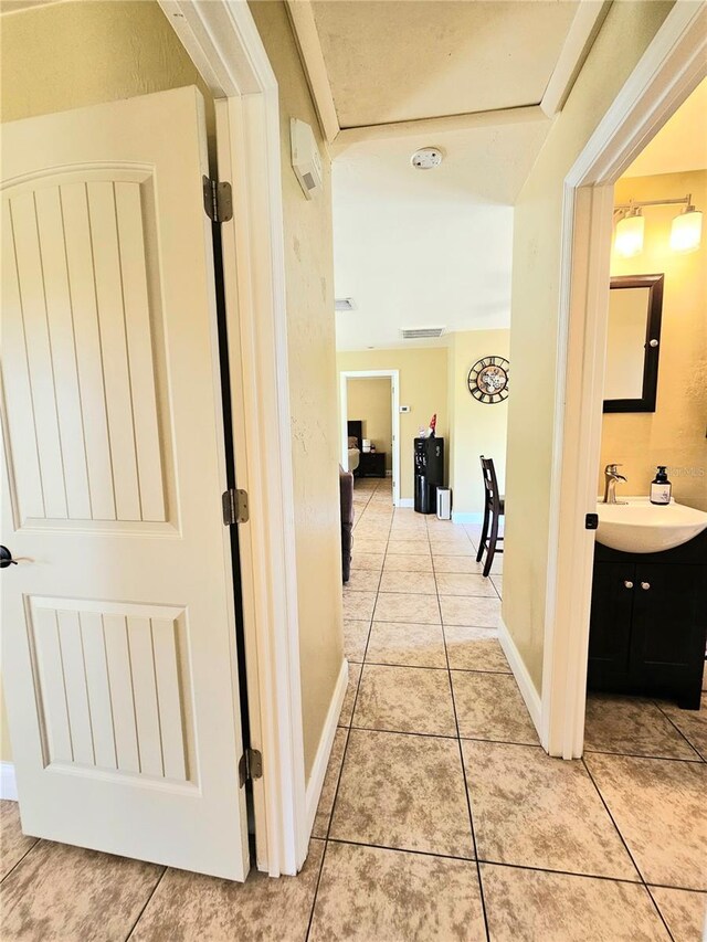 5037 S Obispo Cir, Labelle, FL 33935 - hallway with a sink and light tile patterned floors