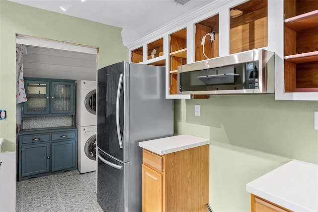 2915 Dean Ridge Rd, Orlando, FL 32825 - kitchen featuring estacked washer and dryer, stainless steel appliances, open shelves, and light countertops