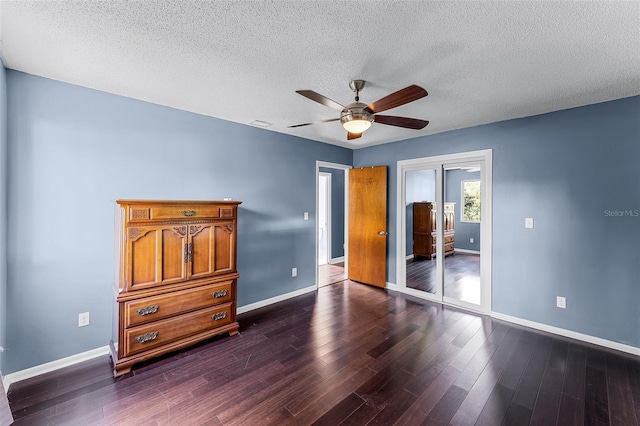 2915 Dean Ridge Rd, Orlando, FL 32825 - unfurnished bedroom featuring dark wood-style flooring, a textured ceiling, and a ceiling fan