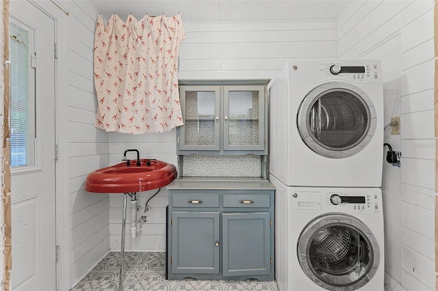 2915 Dean Ridge Rd, Orlando, FL 32825 - laundry room with stacked washer and clothes dryer and wooden walls