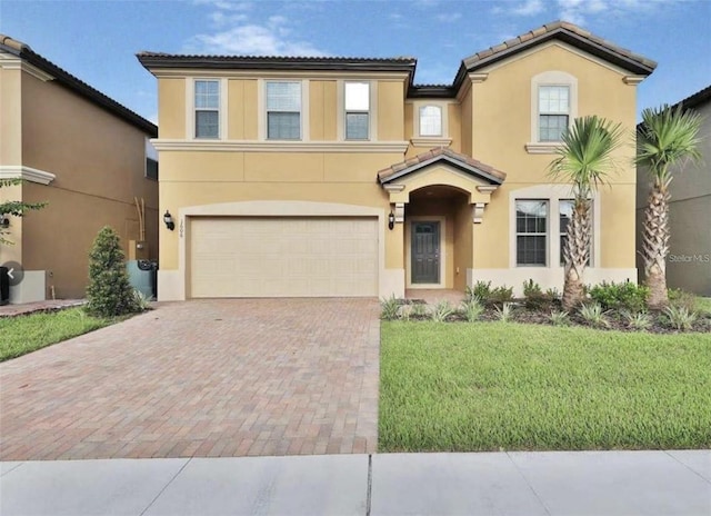 1606 Lima Ave, Kissimmee, FL 34747 - view of front of home featuring stucco siding, decorative driveway, a tile roof, a garage, and a front lawn