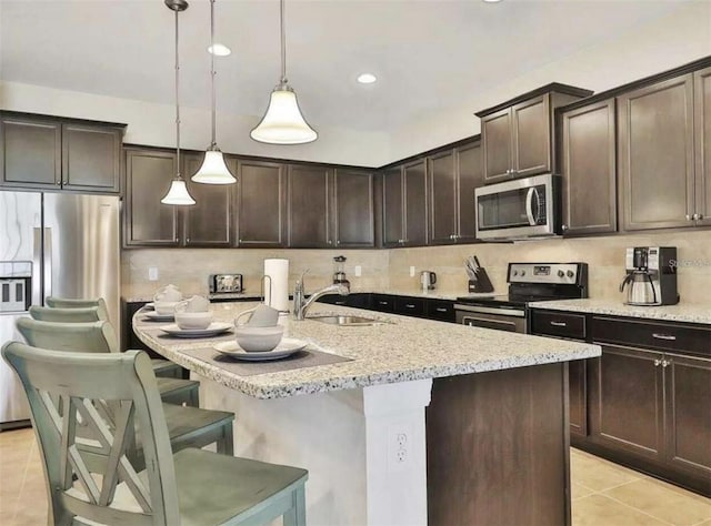 1606 Lima Ave, Kissimmee, FL 34747 - kitchen with appliances with stainless steel finishes, light tile patterned flooring, backsplash, and recessed lighting