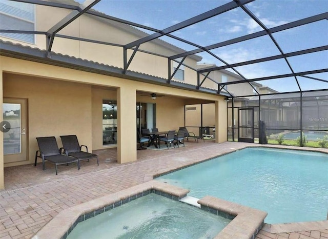 1606 Lima Ave, Kissimmee, FL 34747 - view of pool featuring a patio area, a pool with connected hot tub, and glass enclosure