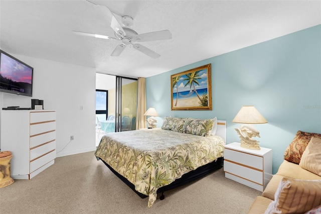 4141 S Atlantic Ave Unit 707, New Smyrna Beach, FL 32169 - bedroom featuring access to outside, ceiling fan, a textured ceiling, and carpet flooring