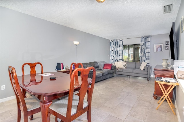 3887 Atrium Dr Unit 3, Orlando, FL 32822 - dining area featuring a textured ceiling